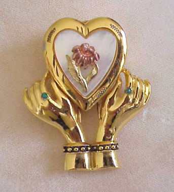  1-7/8 inch double pronged clip, lovely hands holding a heart locket.
