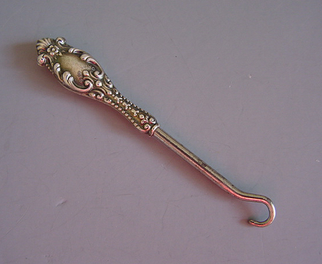 Antique buttonhooks and shoehorns. A buttonhook is a tool used to